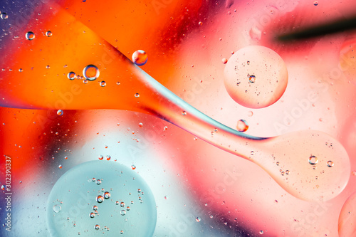 Abstract rainbow color backdrop with oil drops and waves on water surface. 3d render illustration