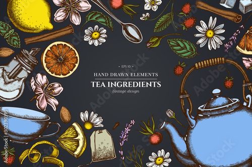 Floral design on dark background with cinnamon, lemons, oranges, tea bag, sugar cubes, heather, chamomile, dog rose, peppermint, almond, strawberry, teaspoon, teapots, cups, sugar bowl