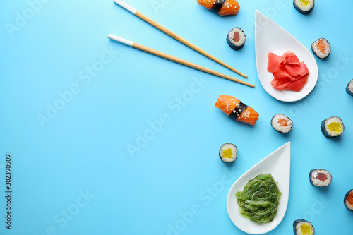 Composition with tasty sushi on color background