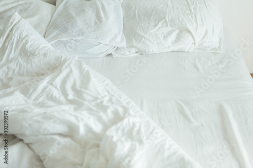 bed with white sheets close up bright light