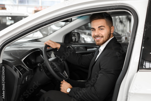 Happy male buyer sitting in new car © Pixel-Shot