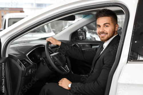 Happy male buyer sitting in new car © Pixel-Shot