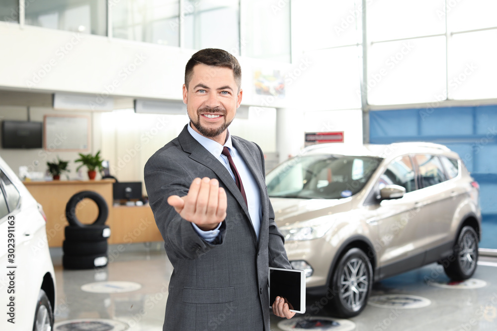 Salesman in modern car salon Salesman in modern car salon