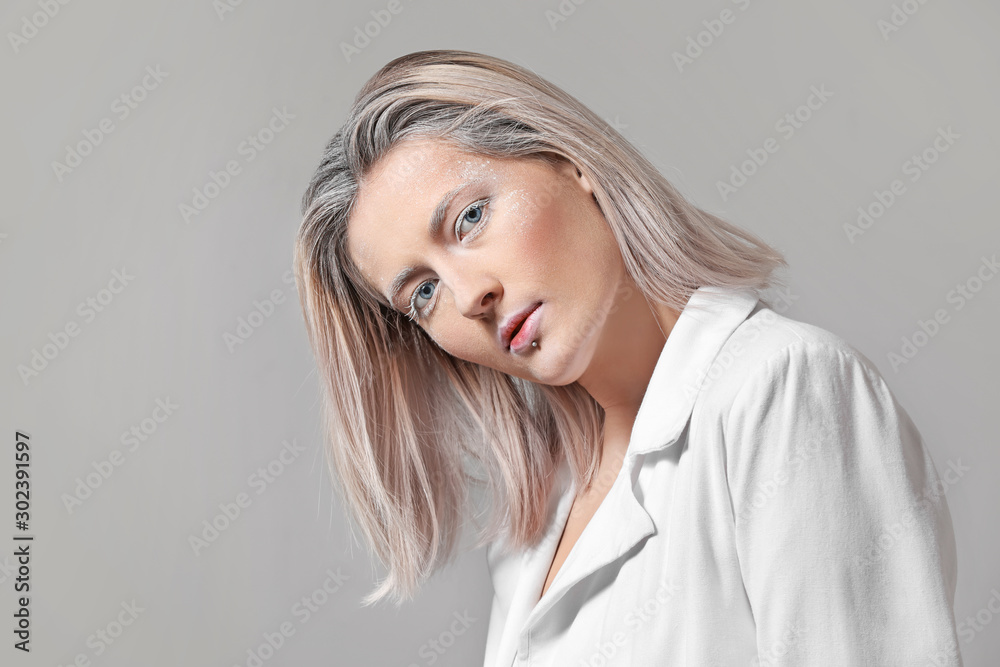 Fototapeta premium Beautiful woman with creative makeup on grey background