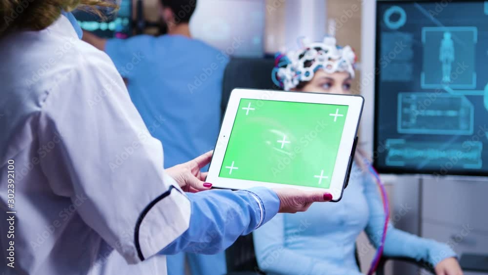 Female doctor holding tablet with green screen in a modern neurology lab science Female doctor holding tablet with green screen in a modern neurology lab science