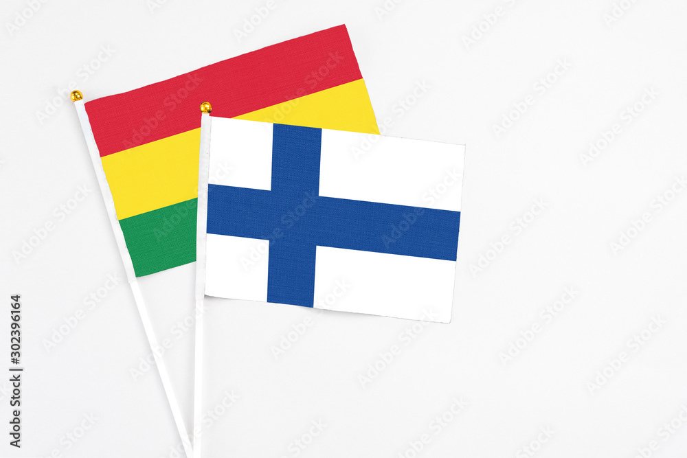 Finland and Bolivia stick flags on white background. High quality fabric, miniature national flag. Peaceful global concept.White floor for copy space. Finland and Bolivia stick flags on white background. High quality fabric, miniature national flag. Peaceful global concept.White floor for copy space.