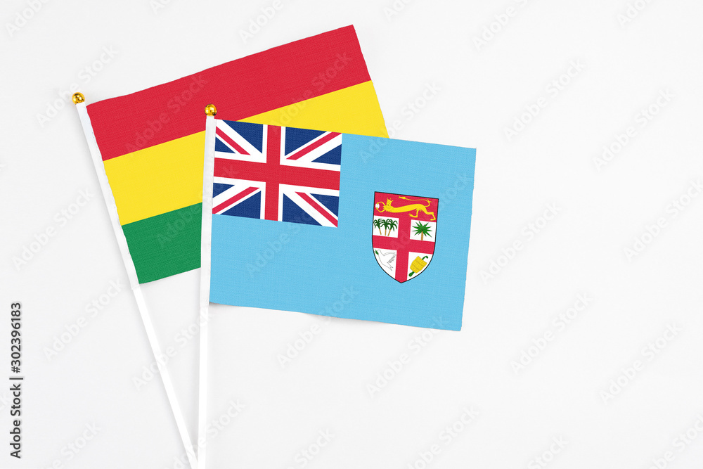 Fiji and Bolivia stick flags on white background. High quality fabric, miniature national flag. Peaceful global concept.White floor for copy space. Fiji and Bolivia stick flags on white background. High quality fabric, miniature national flag. Peaceful global concept.White floor for copy space.