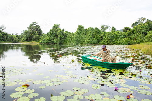 boat on the lake The farmer collected lotus