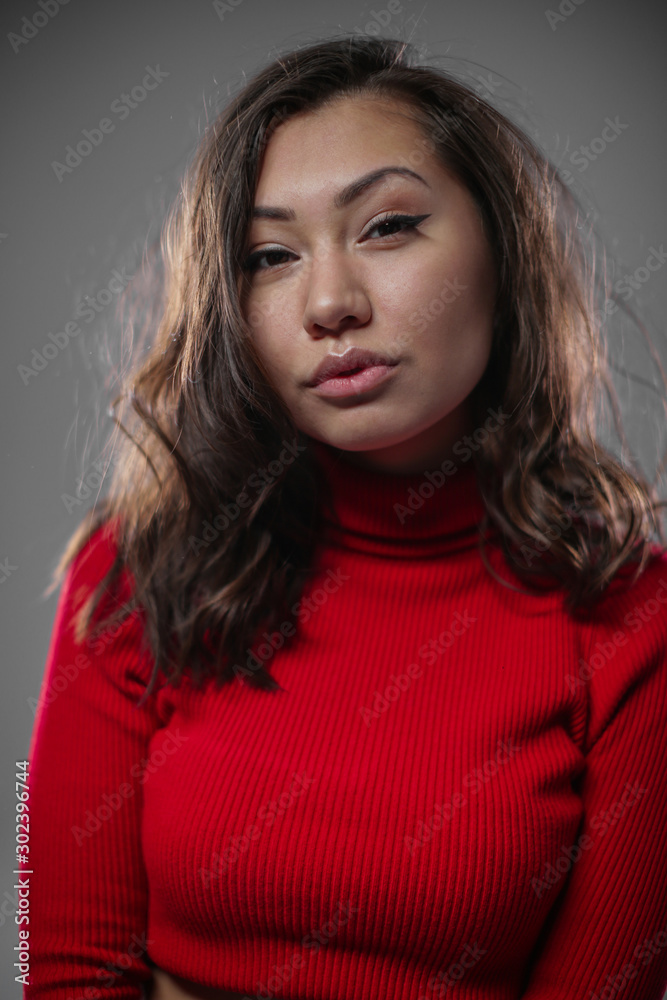 A beautiful Oriental woman languidly looks into the camera. A beautiful Oriental woman languidly looks into the camera.