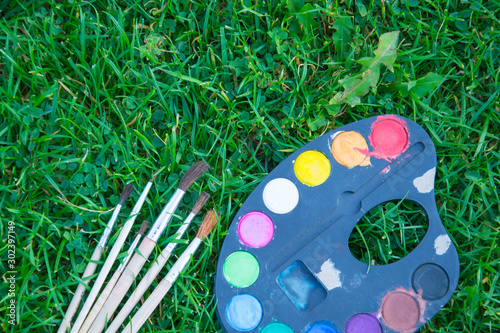Canvas Print Watercolor paints and tassels of different sizes