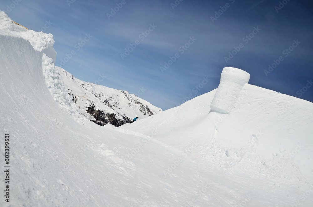 Landscape of winter in mountains Alps with snow and  glacier. Snow sculpture as a attraction of winter holidays.