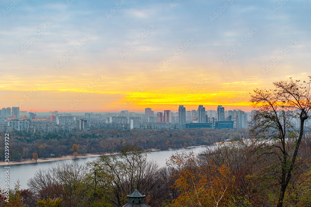 Panorama of Kyiv city and Dnipro river at sunrise in dawn, panoramic view to the colorful autumn cityscape in the morning, Ukraine