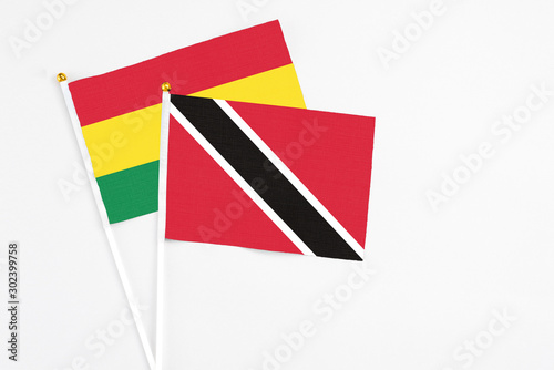 Free Download Trinidad And Tobago and Bolivia stick flags on white background. High quality fabric, miniature national flag. Peaceful global concept.White floor for copy space. - GFXLoad
