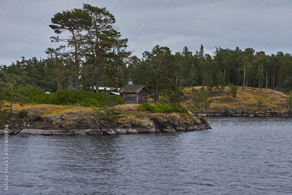 Orthodox chapel.A lonely Orthodox chapel in a forest on the shore of Lake Ladoga on the island of Valaam. The hipped roof and cross on the dome are visible. Russia, Karelia Orthodox chapel.A lonely Orthodox chapel in a forest on the shore of Lake Ladoga on the island of Valaam. The hipped roof and cross on the dome are visible. Russia, Karelia