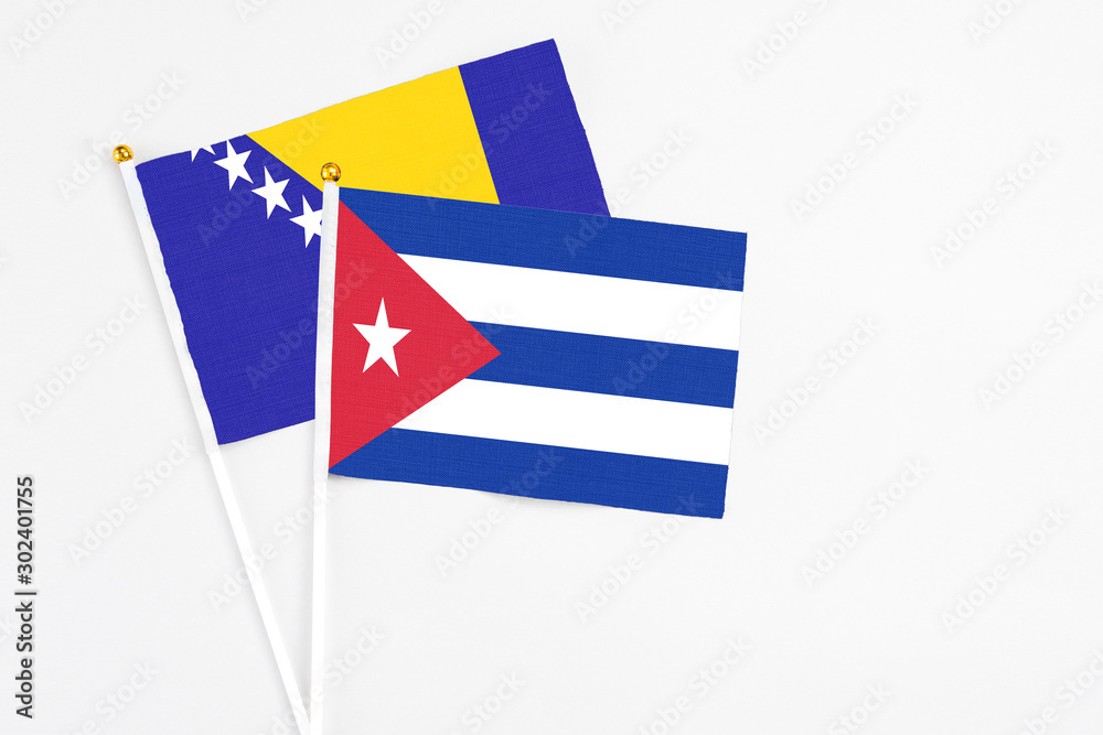 Cuba and Bosnia Herzegovina stick flags on white background. High quality fabric, miniature national flag. Peaceful global concept.White floor for copy space. Cuba and Bosnia Herzegovina stick flags on white background. High quality fabric, miniature national flag. Peaceful global concept.White floor for copy space.