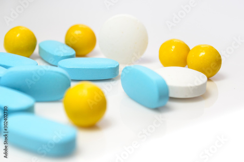 blue, yellow pills on a white background close-up © assoli