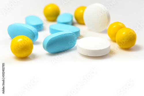 blue, yellow pills on a white background close-up