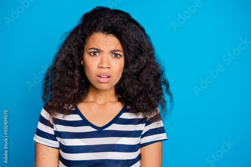 Close up photo of confused frustrated afro american girl hear frightened terrified horrified news information dont believe feel anxious nervous wear casual clothing isolated blue color background