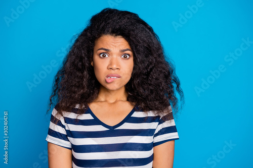 Omg what do. Close up photo of frustrated dark skin girl hear horrible news bite lip panic think she guilty wear casual stylish trendy outfit isolated over blue color background