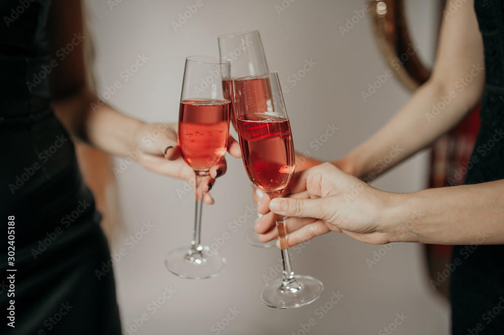 three glasses of champagne in hands on a light background three glasses of champagne in hands on a light background