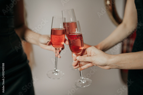  three glasses of champagne in hands on a light background