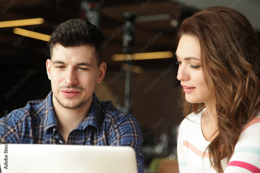 Young people looking at laptop together