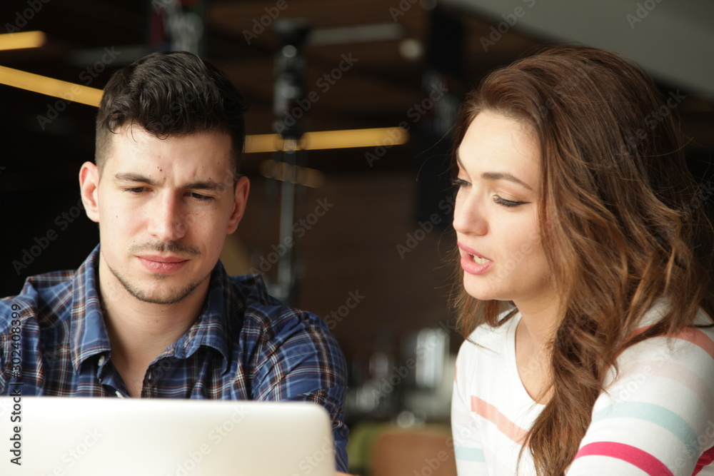 Young people looking at laptop together