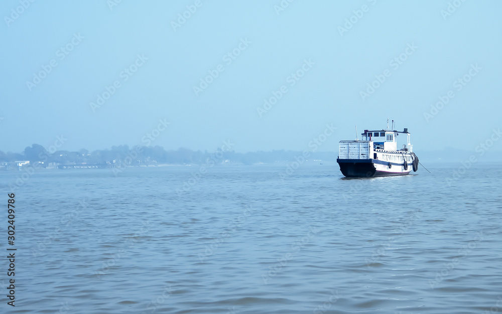 Landscape view of large and heavy rusty cargo container ship on river for transportation of crude oil. International shipment of import and export business and Port navigation background.