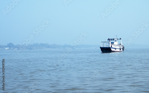 Landscape view of large and heavy rusty cargo container ship on river for transportation of crude oil. International shipment of import and export business and Port navigation background.