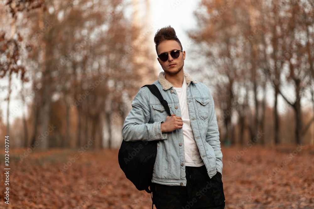 Premium Photo | Trendy young man with hairstyle in trendy denim jacket in  fashion jeans rest on street. stylish serious guy model in fashionable  youth blue denim clothes outdoors. casual menswear from