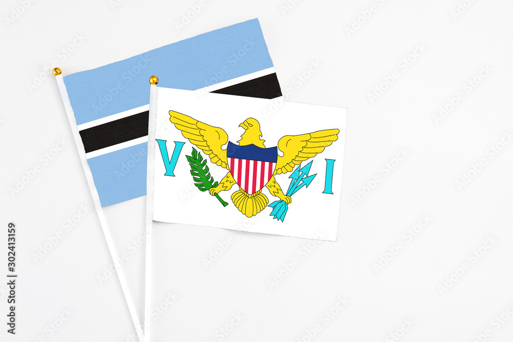 United States Virgin Islands and Botswana stick flags on white background. High quality fabric, miniature national flag. Peaceful global concept.White floor for copy space. United States Virgin Islands and Botswana stick flags on white background. High quality fabric, miniature national flag. Peaceful global concept.White floor for copy space.