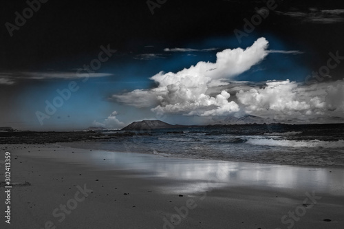 Cloads over Lobos Island viewed from the Natural park of Corralejo in Fuerteventura,La Oliva,Canary Islands,Spain © silvershadows