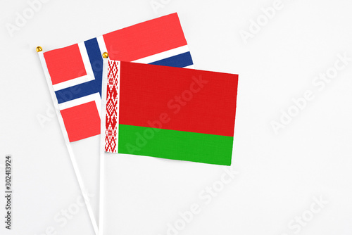 Belarus and Bouvet Islands stick flags on white background. High quality fabric, miniature national flag. Peaceful global concept.White floor for copy space. photo