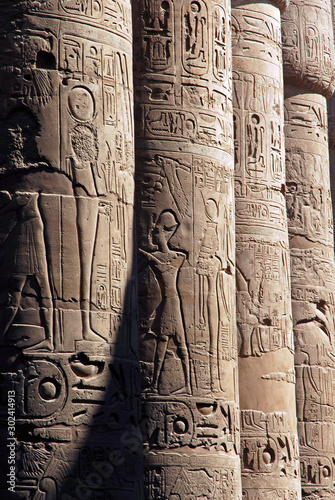 Ancient Egyptian symbols on the pillars of the hypostyle hall. Beautiful Karnak temple in Luxor .