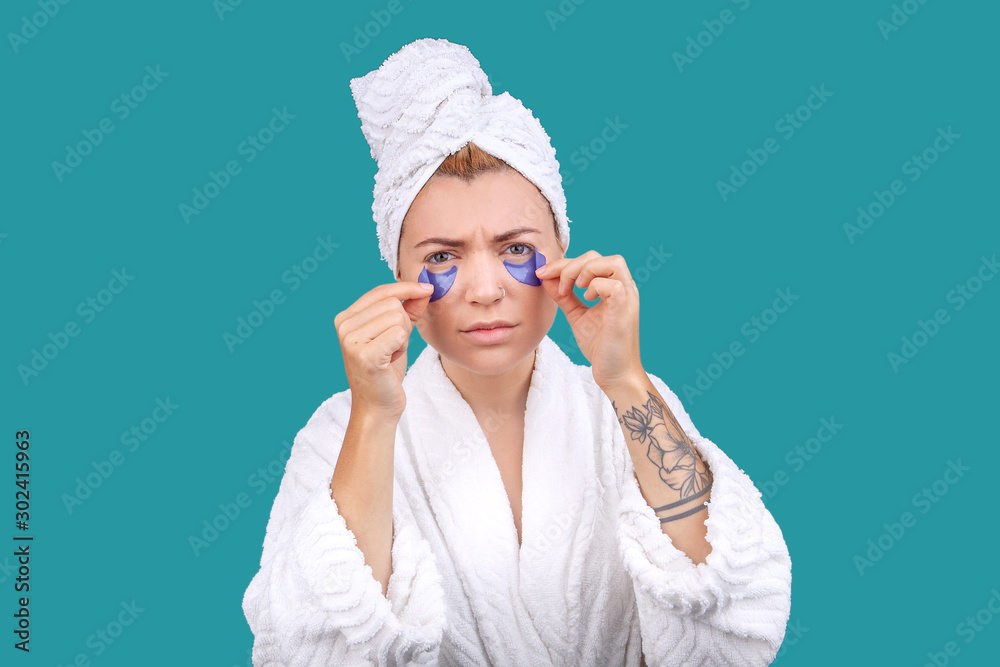 blonde girl in a bathrobe and with patches on her face blonde girl in a bathrobe and with patches on her face