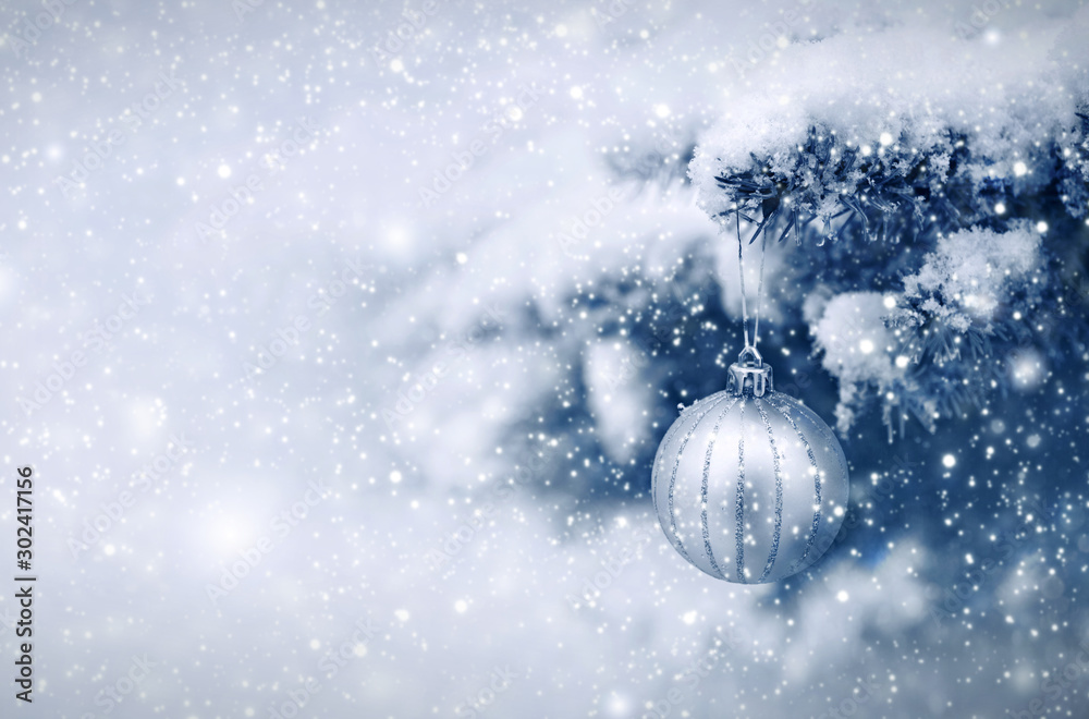 Silver Christmas Ball hanging on a Fir Tree Branch. Christmas Background. - obrazy, fototapety, plakaty 
