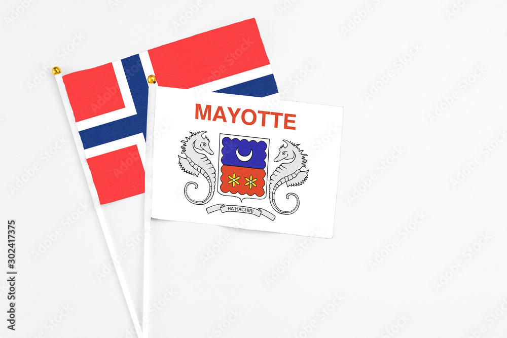 Mayotte and Bouvet Islands stick flags on white background. High quality fabric, miniature national flag. Peaceful global concept.White floor for copy space.
