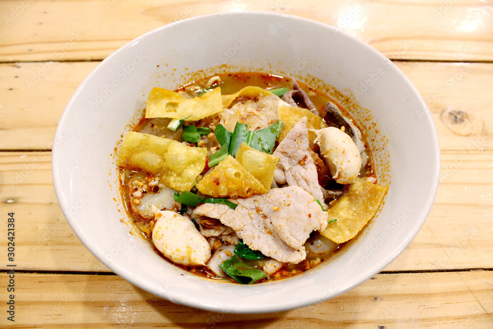 Noodles in thai spicy tom yum soup with pork and pork balls Noodles in thai spicy tom yum soup with pork and pork balls