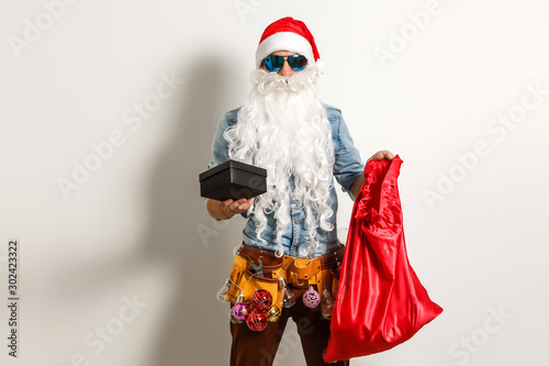 Santa Claus. Young Man with Christmas Gift Boxes Presents Emotional Having Fun Smiling. Handsome Sporty Fashion guy Happy. New Year Holiday.