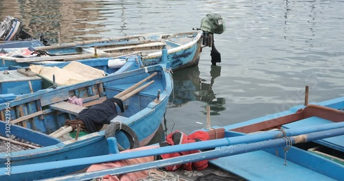 Small fishing boats in the port of Bari. Boats moored at the pier near the fish market.