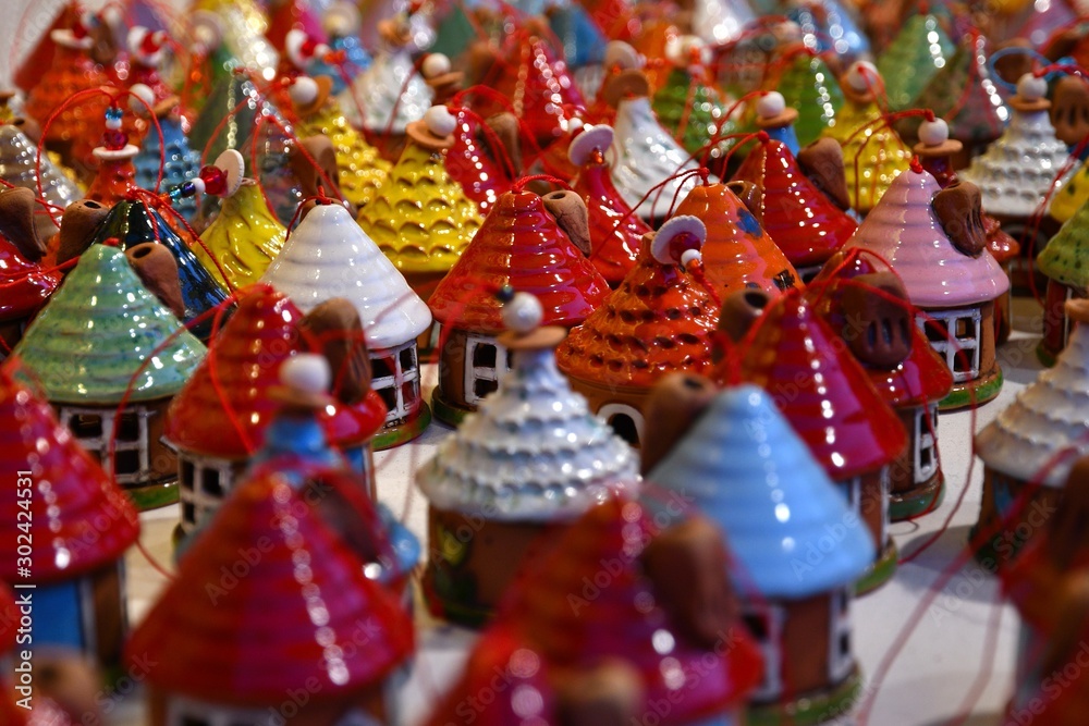 Ornaments in a Christmas Market. colored little houses in a market. Xmas time in Italy.