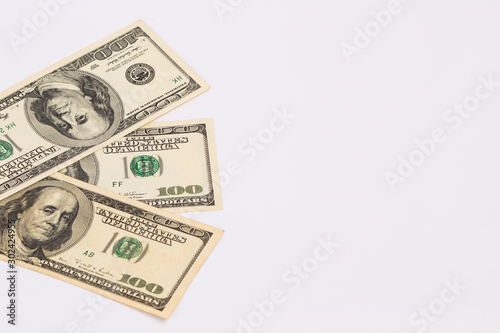Three hundred dollar bills. American banknotes on a white background.