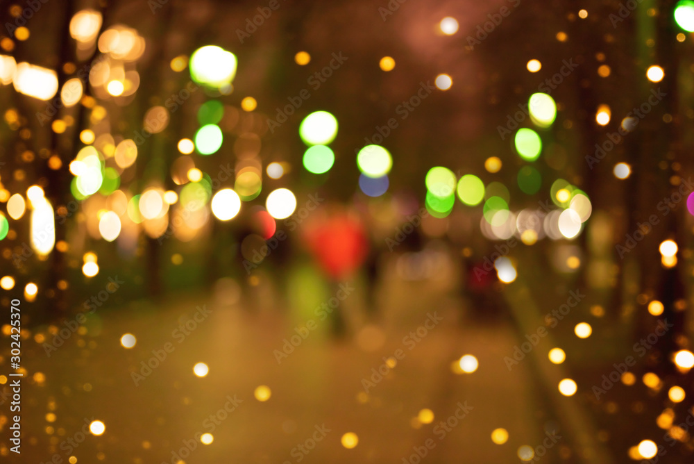 Blurred background. Christmas atmosphere with lights. Urban environment. Blurred background. Christmas atmosphere with lights. Urban environment.