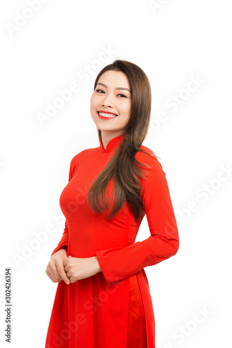 Elegant young Asian woman wear red Ao Dai isolated on white background