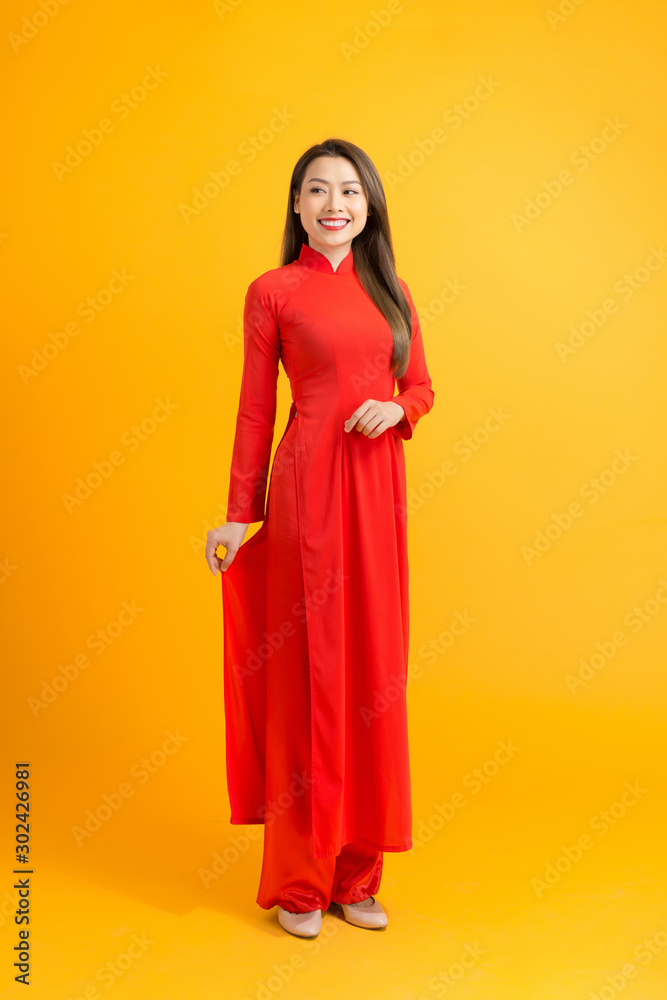 Smiling woman standing in vietnamese traditional costume