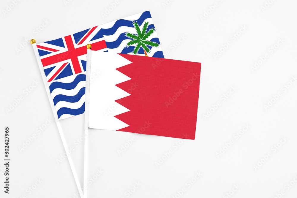 Bahrain and British Indian Ocean Territory stick flags on white background. High quality fabric, miniature national flag. Peaceful global concept.White floor for copy space. Bahrain and British Indian Ocean Territory stick flags on white background. High quality fabric, miniature national flag. Peaceful global concept.White floor for copy space.