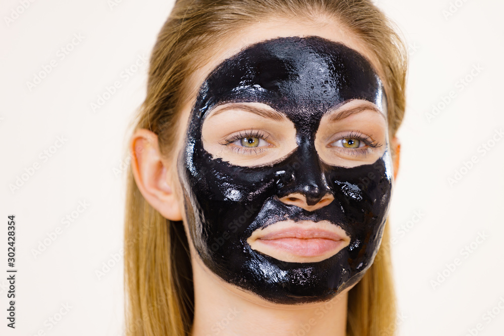 Girl black carbo peel off mask on face Girl black carbo peel off mask on face