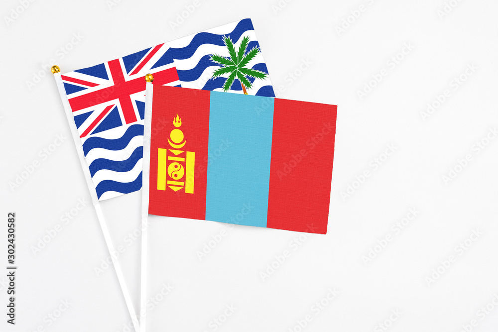 Fototapeta premium Mongolia and British Indian Ocean Territory stick flags on white background. High quality fabric, miniature national flag. Peaceful global concept.White floor for copy space.