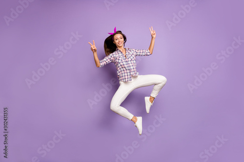 Full body photo of content youth girl enjoy spring weekends jump make v-signs wear casual style clothing sneakers isolated over violet color background