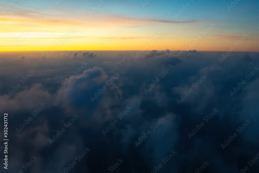 Aerial view from the plane of colorful sky, clouds before sunrise. Soft selective focus